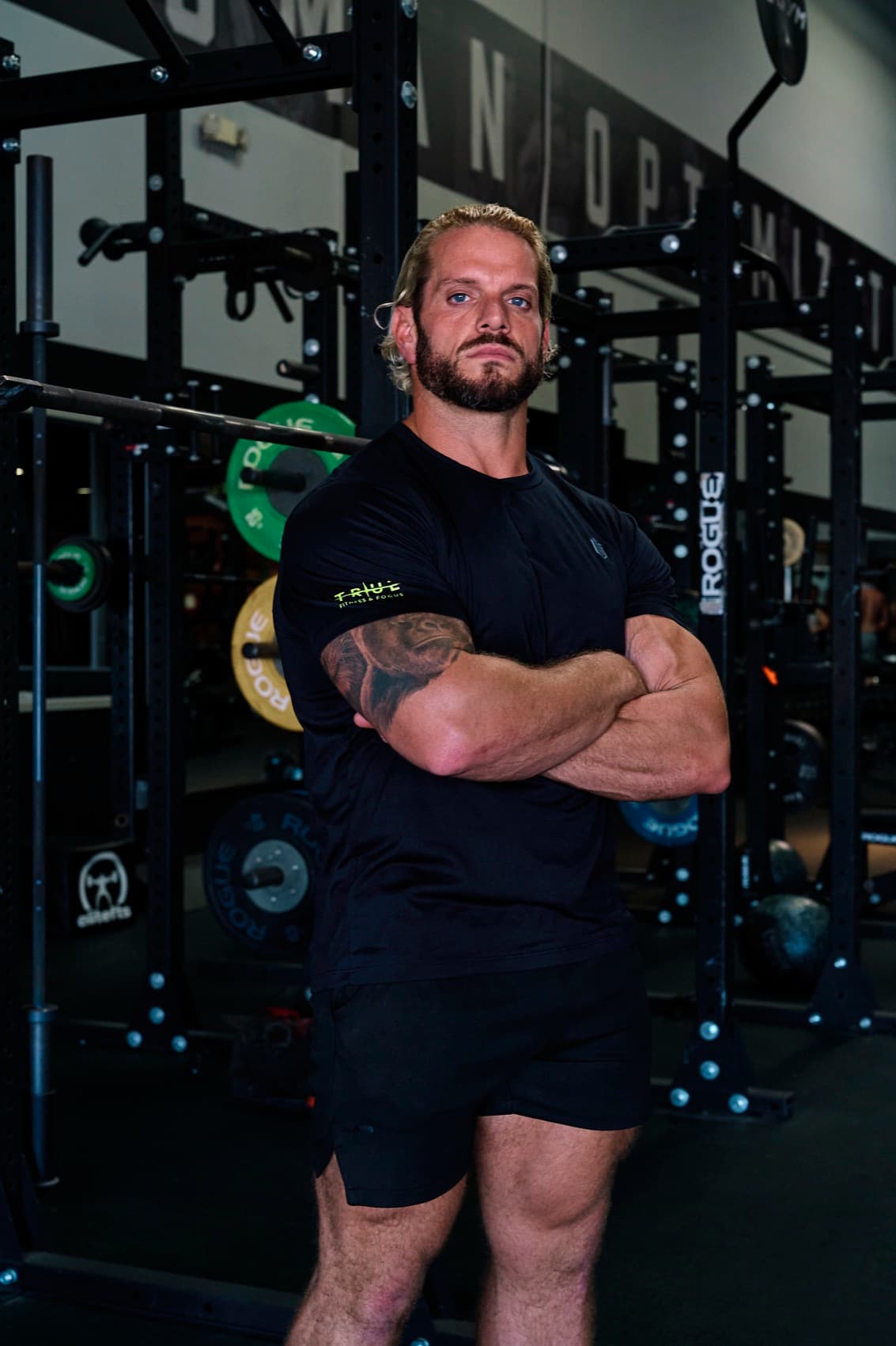 Jarred Curcio standing with arms crossed in the gym