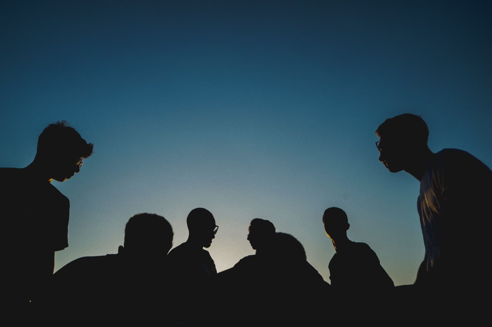 Men in conversation at dusk